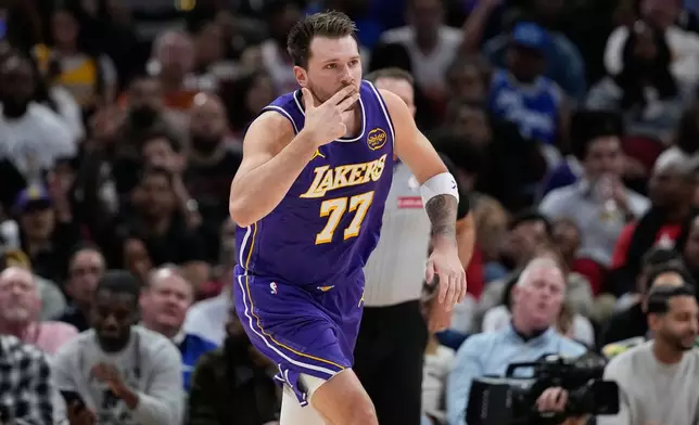 Los Angeles Lakers' Luka Doncic celebrates after making a 3-pointer against the Houston Rockets during the first half of an NBA basketball game Wednesday, March 18, 2026, in Houston. (AP Photo/David J. Phillip)