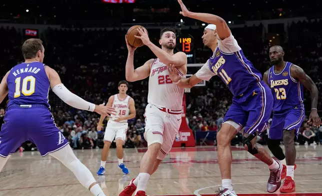 Houston Rockets' Alperen Sengun (28) drives to the basket as Los Angeles Lakers' Jaxson Hayes (11) defends during the first half of an NBA basketball game Wednesday, March 18, 2026, in Houston. (AP Photo/David J. Phillip)