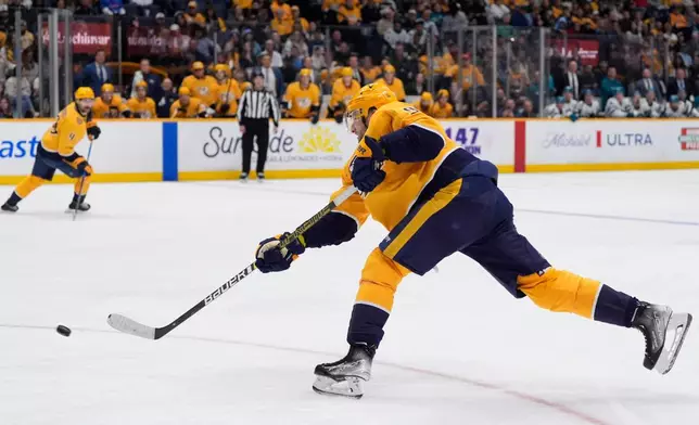 Nashville Predators center Steven Stamkos (91) shoots the puck to score a goal during the second period of an NHL hockey game against the San Jose Sharks, Tuesday, March 24, 2026, in Nashville, Tenn. (AP Photo/George Walker IV)