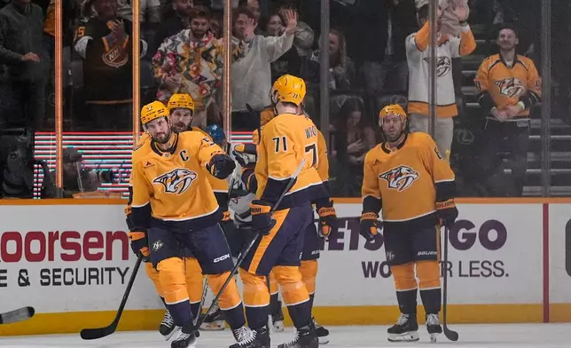 Nashville Predators defenseman Roman Josi, left, celebrates his goal with teammates during the first period of an NHL hockey game against the San Jose Sharks, Tuesday, March 24, 2026, in Nashville, Tenn. (AP Photo/George Walker IV)