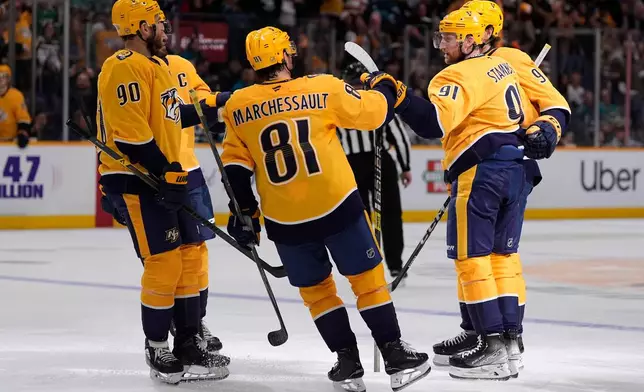 Nashville Predators teammates congratulate Nashville Predators center Steven Stamkos (91) after his goal during the second period of an NHL hockey game against the San Jose Sharks, Tuesday, March 24, 2026, in Nashville, Tenn. (AP Photo/George Walker IV)