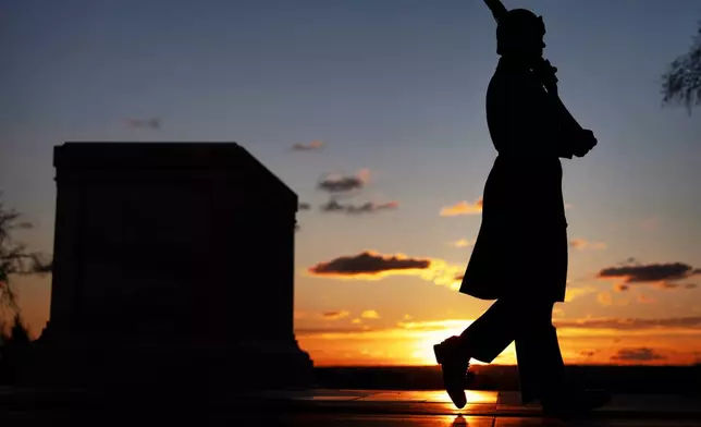 A U.S. Army honor guard member stands vigil at dawn at the Tomb of the Unknown Soldier on Tuesday, March 17, 2026, at Arlington National Cemetery in Arlington, Va., ahead of the 100th anniversary of a continuous honor guard presence at the tomb, celebrated March 25, 2026. (AP Photo/Mark Schiefelbein)