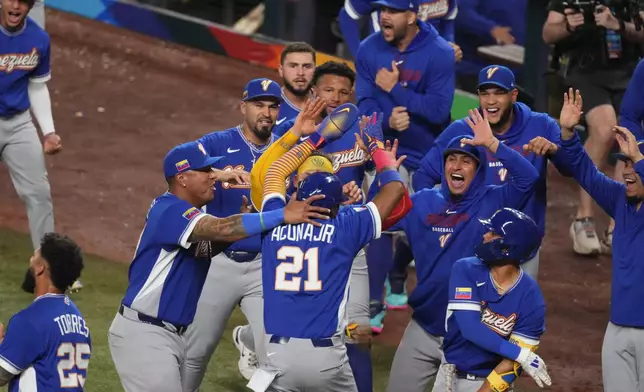 Venezuela Ronald Acuña Jr. (21) celebrates after scoring during the seventh inning of a World Baseball Classic semifinal game against Italy, Monday, March 16, 2026, in Miami. (AP Photo/Lynne Sladky)
