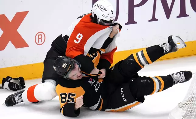 Pittsburgh Penguins' Avery Hayes (85) and Philadelphia Flyers' Jamie Drysdale (9) fight during the first period of an NHL hockey game in Pittsburgh, Saturday, March 7, 2026. (AP Photo/Gene J. Puskar)