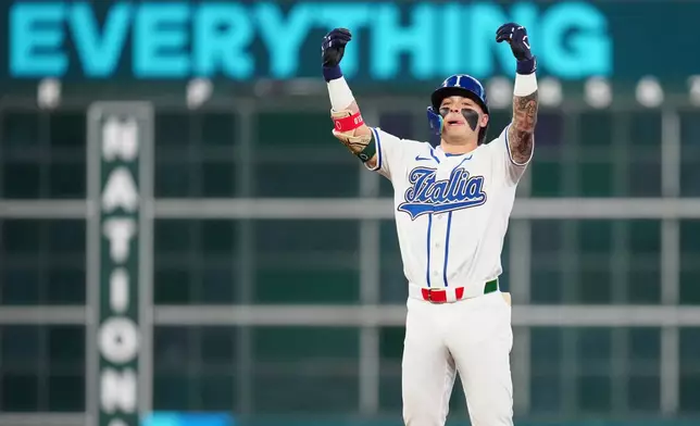 Italy's Andrew Fischer celebrates after hitting a two-run double during the fourth inning of a World Baseball Classic quarterfinal game against Puerto Rico, Saturday, March 14, 2026, in Houston. (AP Photo/Karen Warren)