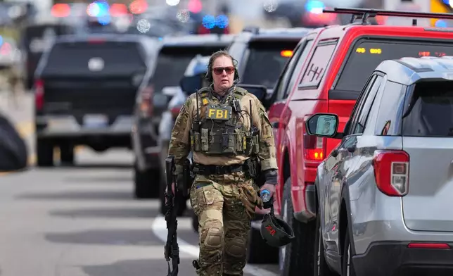 Law enforcement respond to a call at Temple Israel synagogue Thursday, March 12, 2026, in West Bloomfield Township, Mich. (AP Photo/Paul Sancya)