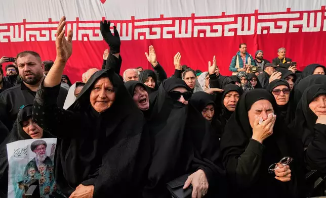Mourners react during the funeral ceremony for Gen. Ali Shamkhani, secretary of Iran's Defense Council and a senior adviser to the Supreme Leader who was killed in a strike, at the courtyard of the Imamzadeh Saleh shrine in Tehran, Iran, Saturday, March 14, 2026. (AP Photo/Vahid Salemi)