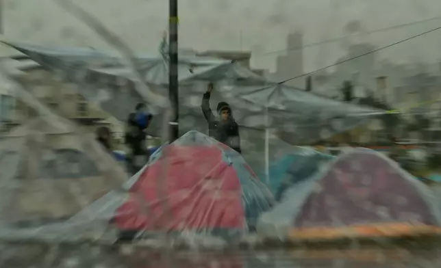 Heavy rain falls over tents sheltering people displaced by Israeli airstrikes in southern Lebanon and Dahiyeh, Beirut's southern suburbs, along the Beirut waterfront in Beirut, Lebanon, Sunday, March 15, 2026. (AP Photo/Hassan Ammar)