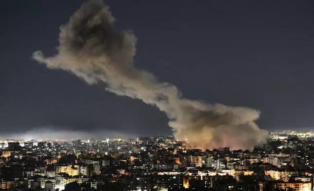 Smoke rises from Israeli airstrikes that struck a building housing Al-Manar channel studios in Dahiyeh, a southern suburb of Beirut, Lebanon, early on Tuesday, March 3, 2026. (AP Photo/Bilal Hussein)