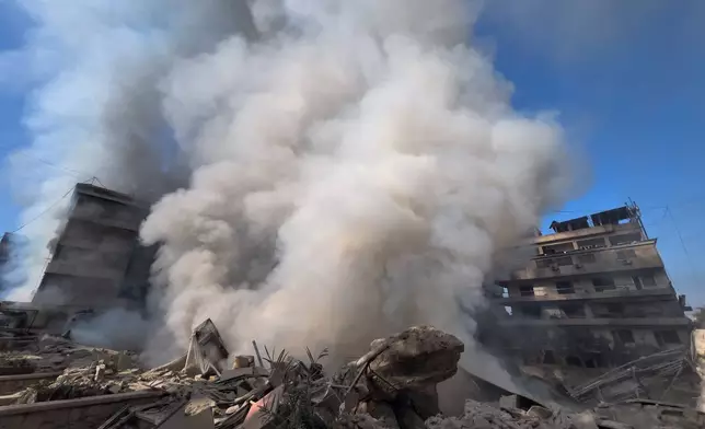 Smoke rises from a destroyed building that was hit by an Israeli airstrike in Dahiyeh, a southern suburb of Beirut, Lebanon, Tuesday, March 3, 2026. (AP Photo/Hussein Malla)