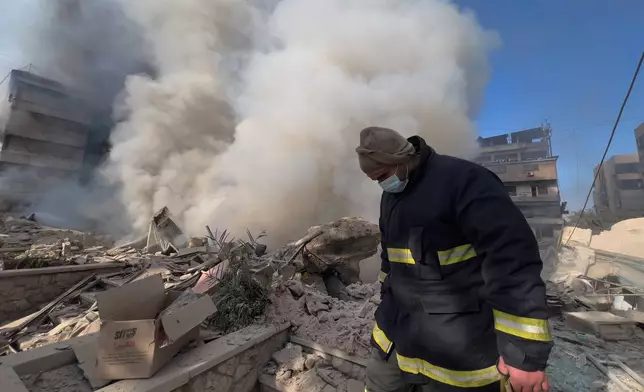 A rescue worker checks the site where several buildings were hit by Israeli airstrikes in Dahiyeh, a southern suburb of Beirut, Lebanon, Tuesday, March 3, 2026. (AP Photo/Hussein Malla)