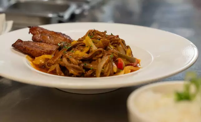 A ropa vieja dish from Cuba Libre Restaurant and Rum Bar's standard menu is prepared for serving at Cuba Libre Restaurant and Rum Bar in Philadelphia, on Friday, March 6, 2026. (AP Photo/Mingson Lau)