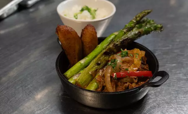 A ropa vieja dish from Cuba Libre Restaurant and Rum Bar's GLP-Wonderful menu is prepared for serving at the restaurant in Philadelphia, on Friday, March 6, 2026. (AP Photo/Mingson Lau)