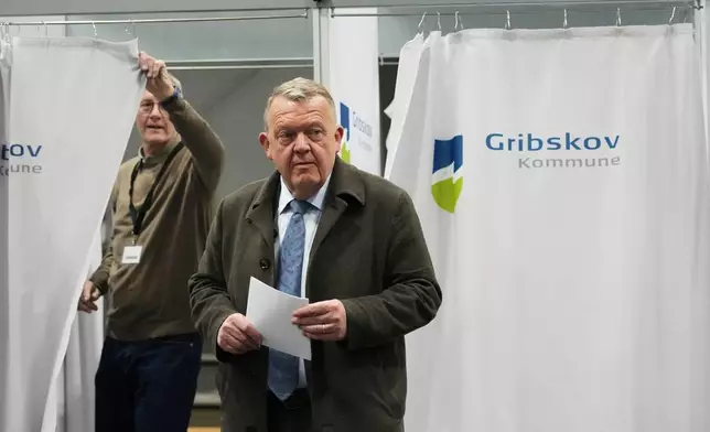 Chairman of the Moderates party and Denmark's Foreign Minister Lars Loekke Rasmussen holds his ballot at a poling station in Græsted, Denmark, on Tuesday, March 24, 2026, during the general election. (AP Photo/Sergei Grits)