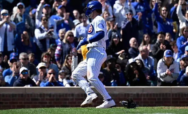 Chicago Cubs' Nico Hoerner scores during the second inning of a baseball game against the Washington Nationals, Saturday, March 28, 2026, in Chicago. (AP Photo/Matt Marton)