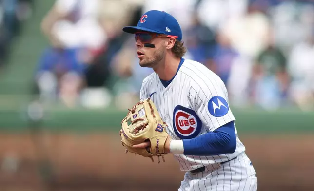 Chicago Cubs second baseman Nico Hoerner (2) prepares to field the ball during the first inning of a baseball game against the Washington Nationals at Wrigley Field on Sunday, March 29, 2026, in Chicago. (AP Photo/Geoff Stellfox)