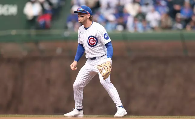 Chicago Cubs second baseman Nico Hoerner (2) prepares to field the ball during the first inning of a baseball game against the Washington Nationals at Wrigley Field on Sunday, March 29, 2026, in Chicago. (AP Photo/Geoff Stellfox)