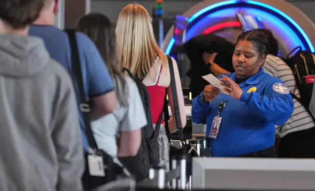 A TSA worker checks passengers at Greater Pittsburgh International Airport in Imperial, Pa., Thursday, March 26, 2026. (AP Photo/Gene J. Puskar)