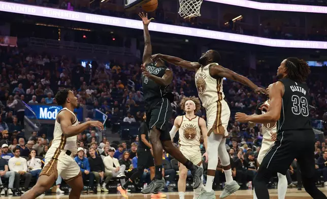 Brooklyn Nets guard Drake Powell (4) shoots against Golden State Warriors forward Draymond Green (23) during the first half of an NBA basketball game in San Francisco, Wednesday, March 25, 2026. (AP Photo/Jed Jacobsohn)