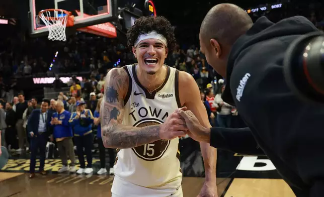 Golden State Warriors forward Gui Santos (15) celebrates with teammate Al Horford, right, after an NBA basketball game against the Brooklyn Nets in San Francisco, Wednesday, March 25, 2026. (AP Photo/Jed Jacobsohn)