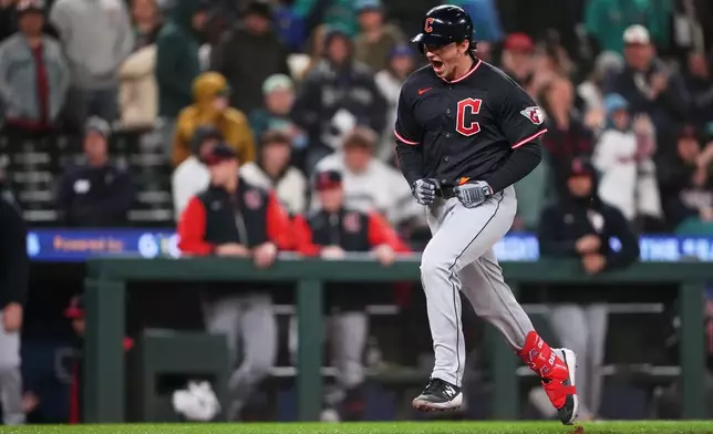 Cleveland Guardians' Chase DeLauter yells while running the bases after hitting a two-run home run against the Seattle Mariners during the 10th inning of a baseball game, Saturday, March 28, 2026, in Seattle. (AP Photo/Lindsey Wasson)