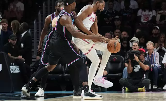 Houston Rockets forward Kevin Durant, right, loses control of the ball as Miami Heat center Bam Adebayo, left, defends during the first half of an NBA basketball game, Saturday, Feb. 28, 2026, in Miami. (AP Photo/Lynne Sladky)