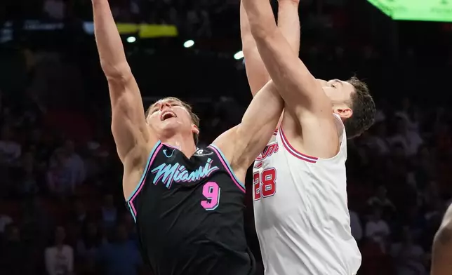 Miami Heat guard Pelle Larsson (9) goes to the basket as Houston Rockets center Alperen Sengun (28) defends during the first half of an NBA basketball game, Saturday, Feb. 28, 2026, in Miami. (AP Photo/Lynne Sladky)