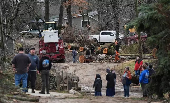 Volunteers work to clear up debris in the aftermath of a powerful storm that ripped through the area a day earlier, in Union City Mich., Saturday, March 7, 2026. (AP Photo/Nam Y. Huh)