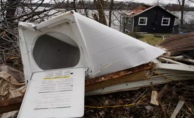 A warped washing machine sits amid debris in the aftermath of a powerful storm that ripped through the area a day earlier, in Union City Mich., Saturday, March 7, 2026. (AP Photo/Nam Y. Huh)