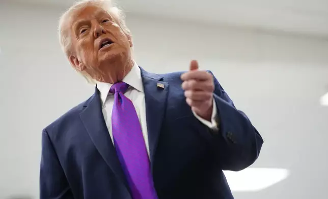 President Donald Trump talks with reporters as he visits Thermo Fisher Scientific, Wednesday, March 11, 2026, in Cincinnati. (AP Photo/Julia Demaree Nikhinson)