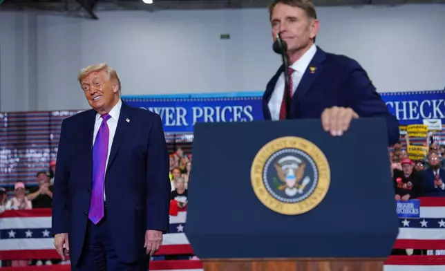 President Donald Trump listens as congressional candidate Ed Gallrein speaks at Verst Logistics Wednesday, March 11, 2026, in Hebron, Ky. (AP Photo/Julia Demaree Nikhinson)