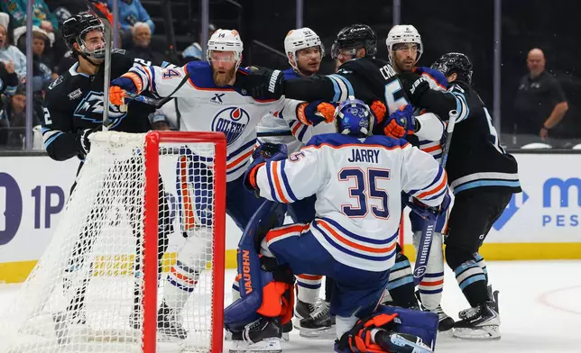 Utah Mammoth center Jack McBain (22) and left wing Lawson Crouse (67) get into a fight against the Edmonton Oilers defenseman Mattias Ekholm (14), right wing Vasily Podkolzin (92) and defenseman Evan Bouchard (2) during the second period of an NHL hockey game, Tuesday, March 24, 2026, in Salt Lake City. (AP Photo/Melissa Majchrzak)