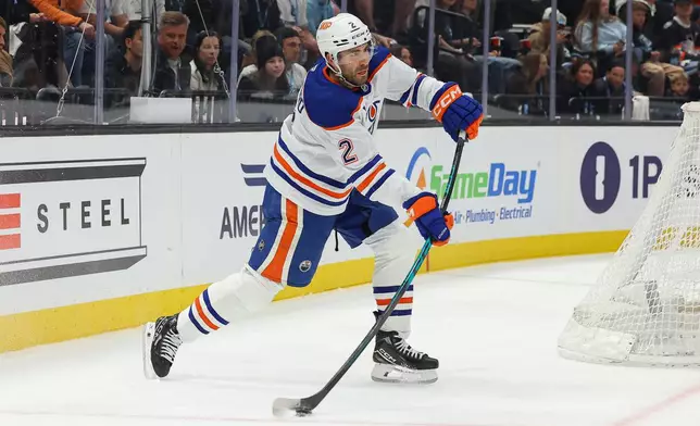 Edmonton Oilers defenseman Evan Bouchard (2) passes the puck against the Utah Mammoth during the second period of an NHL hockey game, Tuesday, March 24, 2026, in Salt Lake City. (AP Photo/Melissa Majchrzak)