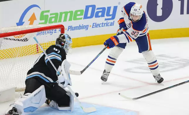 Utah Mammoth goaltender Vitek Vanecek (41) stops the puck against Edmonton Oilers center Ryan Nugent-Hopkins (93) during the third period of an NHL hockey game, Tuesday, March 24, 2026, in Salt Lake City. (AP Photo/Melissa Majchrzak)