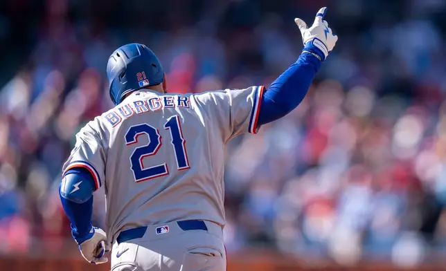 Texas Rangers' Jake Burger reacts to his two-run home run during the third inning of a baseball game against the Philadelphia Phillies, Saturday, March 28, 2026, in Philadelphia. (AP Photo/Chris Szagola)