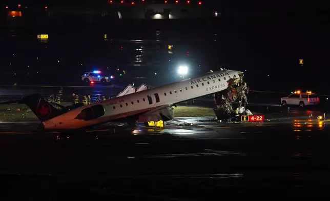 An Air Canada Jet sits on the runway at LaGuardia Airport, Monday, March 23, 2026, after colliding with a Port Authority aircraft rescue and firefighting vehicle in New York. (AP Photo/Ryan Murphy)
