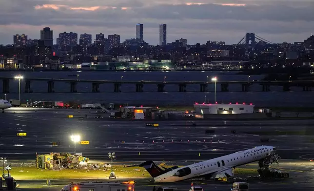 An Air Canada jet and Port Authority fire truck sit on the runway at LaGuardia Airport, Monday, March 23, 2026, after colliding with each other after the jet landed Sunday night in New York. (AP Photo/Seth Wenig)