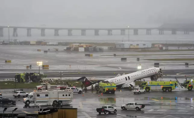 An Air Canada jet and Port Authority fire truck sit on the runway at LaGuardia Airport, Monday, March 23, 2026, after colliding with each other after the Jet landed Sunday night in New York. (AP Photo/Seth Wenig)
