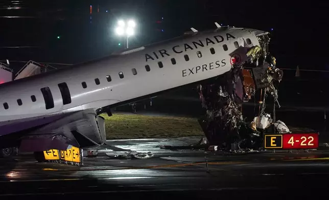 An Air Canada Jet sits on the runway at LaGuardia Airport, Monday, March 23, 2026, after colliding with a Port Authority aircraft rescue and firefighting vehicle after landing in New York. (AP Photo/Ryan Murphy)