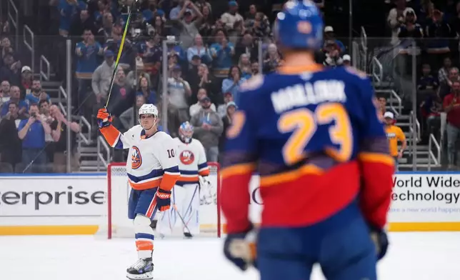 New York Islanders' Brayden Schenn (10) is honored during a time out during the first period of an NHL hockey game against the St. Louis Blues Tuesday, March 10, 2026, in St. Louis. (AP Photo/Jeff Roberson)