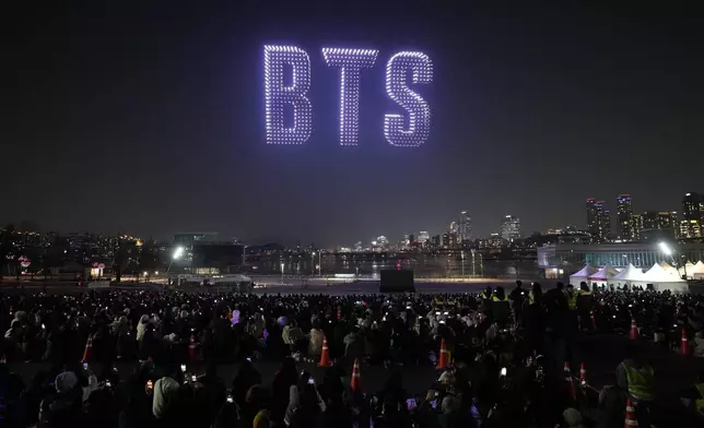 Drones light up the night sky during a drone light show to celebrate the comeback of the K-pop band BTS at a park along the Han River in Seoul, South Korea, Friday, March 20, 2026. (AP Photo/Lee Jin-man)