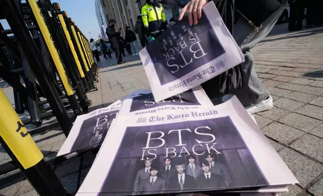 Copies of special edition of The Korea Herald newspaper reporting the comeback of K-pop band BTS are seen near Gwanghwamun Square in Seoul, South Korea, Saturday, March 21, 2026. (AP Photo/Ahn Young-joon)