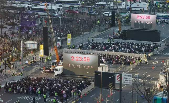 Fans of BTS wait for a comeback concert of K-pop band BTS near Gwanghwamun Square in Seoul, South Korea, Saturday, March 21, 2026. (AP Photo/Ahn Young-joon)