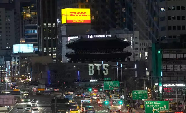A logo of K-pop band BTS is displayed at Sungnyemun Gate in Seoul, South Korea, Friday, March 20, 2026, ahead of their comeback concert. (AP Photo/Ahn Young-joon)