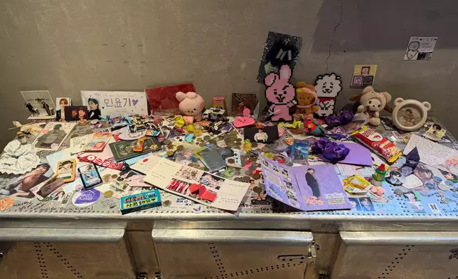 Letters, photographs, and trinkets from around the world, are displayed at Cafe HYUGA, a former trainee dormitory for K-pop band BTS, now converted into a cafe, in Seoul, South Korea, Friday, March 20, 2026. (AP Photo/Juwon Park)