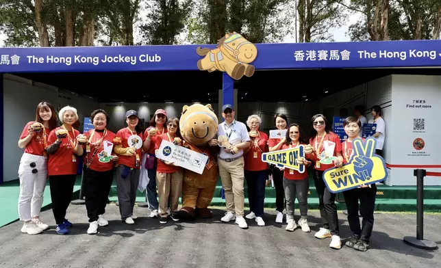 Members of the Club’s CARE@HKJC Volunteer Team create balloon figures to bring joy to spectators at the fan village and pose for a photo with Raymond Tam, Executive Director of Corporate Affairs of The Hong Kong Jockey Club (photo 9, 6th right).