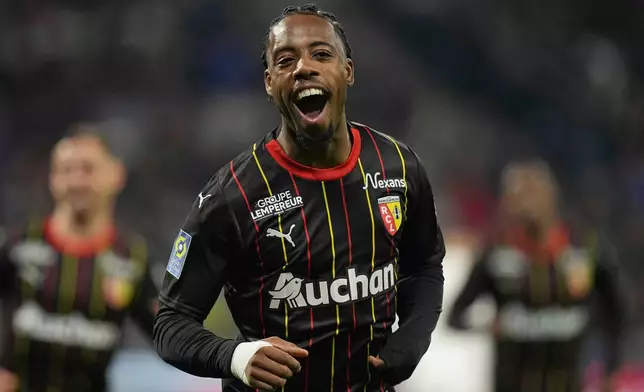 FILE - Lens' Elye Wahi celebrates after scoring his side' second goal during the French League One soccer match between Lyon and Lens at the Groupama stadium, outside Lyon, France, Sunday, March 3, 2024. (AP Photo/Laurent Cipriani, File)