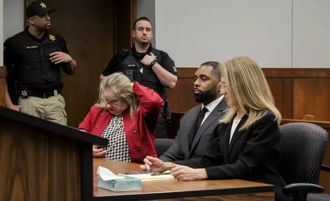 Sherrone Moore appears with his attorney, Ellen Michaels, right for a hearing, Friday, March 6 2026, at Washtenaw County 14A-1 District in Ann Arbor, Mich. (Jordyn Pair/Ann Arbor News via AP)