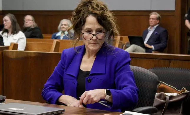 Washtenaw County assistant prosecutor Kati Rezmierski takes her seat as Sherrone Moore appears for a hearing, Friday, March 6 2026, at Washtenaw County 14A-1 District in Ann Arbor, Mich. (Jordyn Pair/Ann Arbor News via AP)