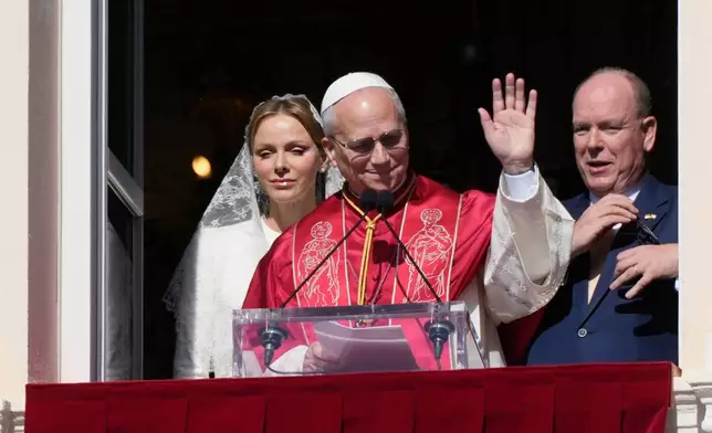 Pope Leo XIV, Princess Charlene of Monaco and Prince Albert II of Monaco appear at the Gallery of Hercules balcony at the Prince's Palace in Monaco-Ville, Monaco, Saturday, March 28, 2026.(AP Photo/Gregorio Borgia)